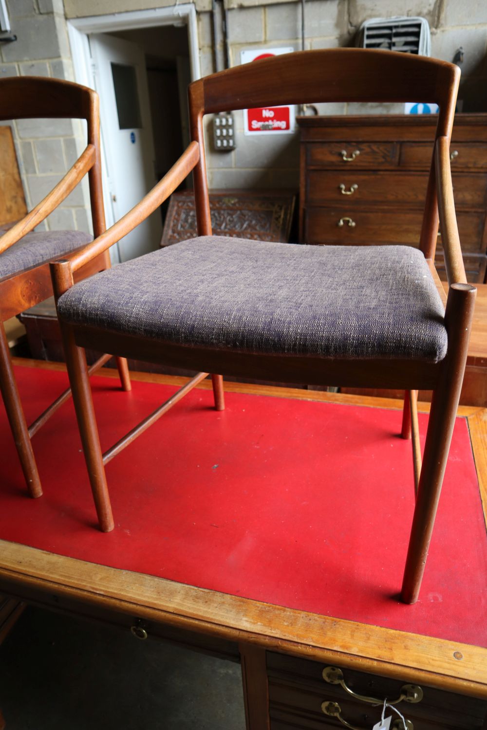 A set of four mid century Danish teak elbow chairs